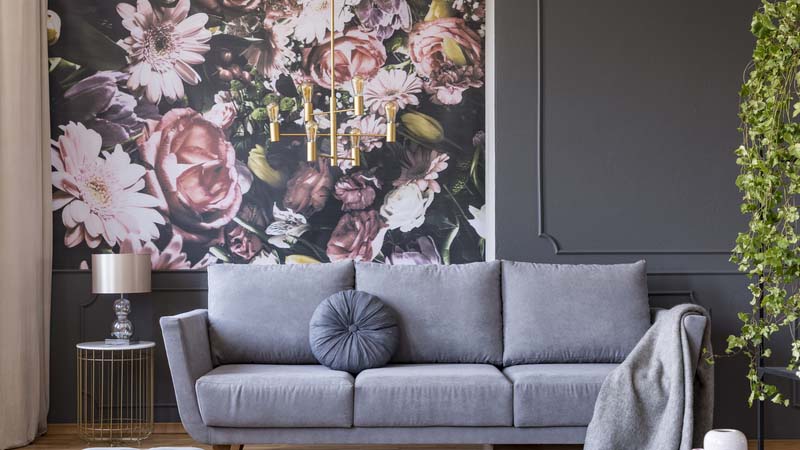 grey living area with pink flowery wallpaper